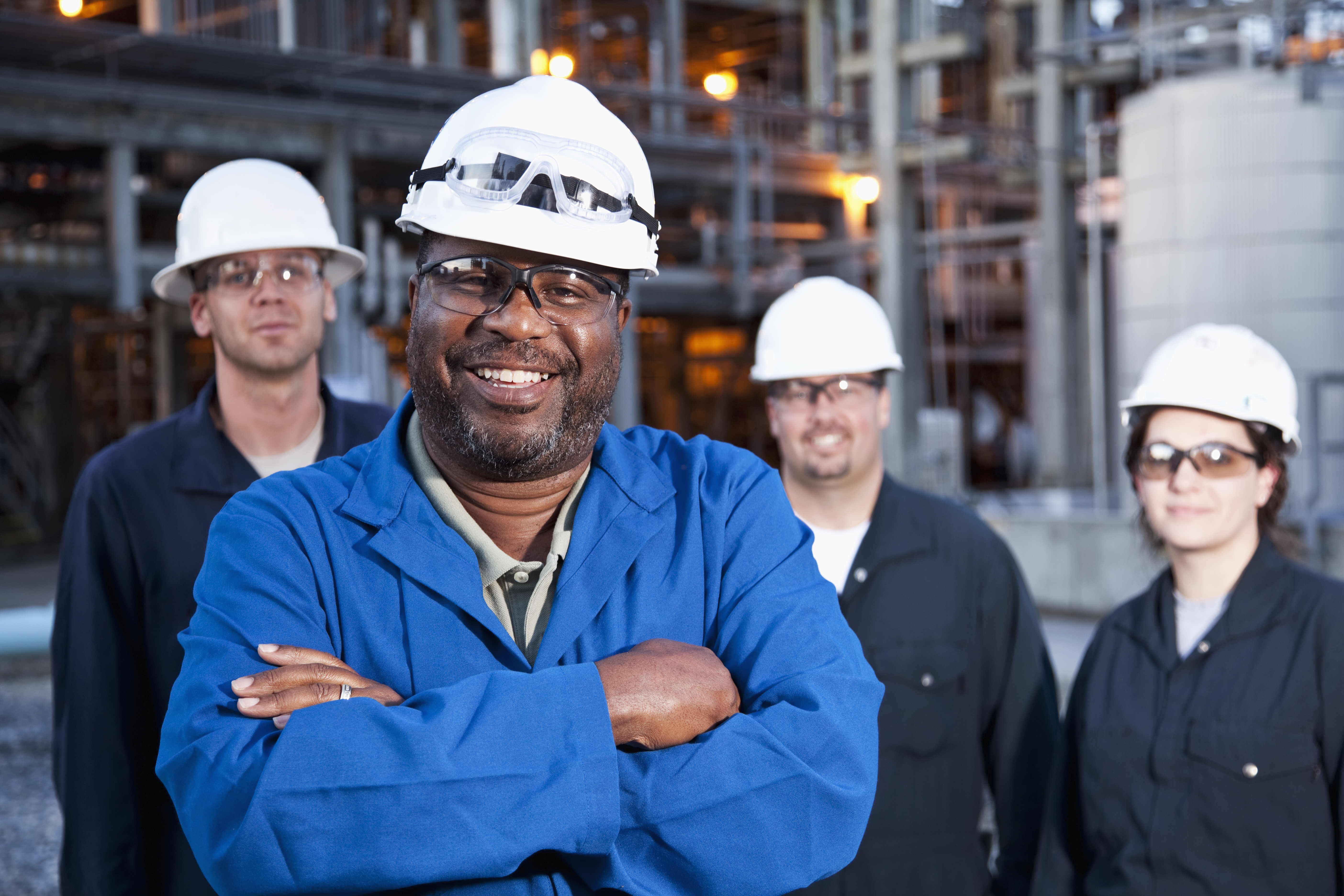 Workers standing in front of factory.