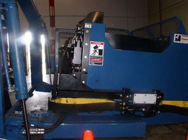 The lower part of the blue collection bin shows two pincher arms that are connected by a metal hinge.