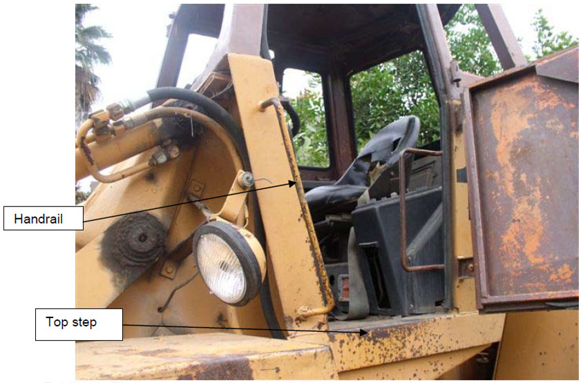 The driver's cab has a narrow ledge for the driver to step onto when entering and exiting. There is a thin handrail to grab onto that does not extend beneath the cab.