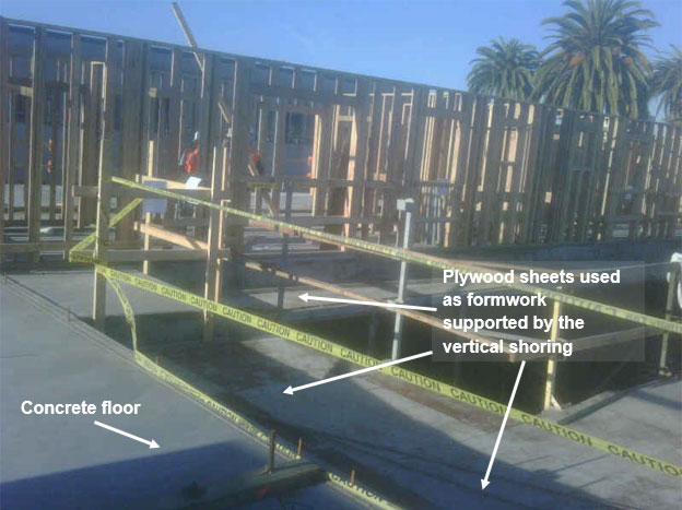 The second floor showing the plywood boards next to more supportive concrete flooring.