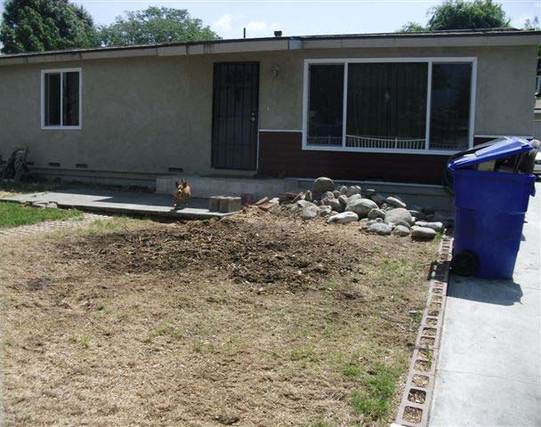 Front yard of house where incident occurred after tree removal with a large patch near the front porch.