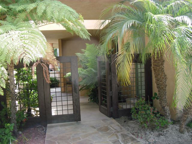 Breezeway entry showing hard stone surface on ground where worker fell from the opening in the partially covered walkway above.