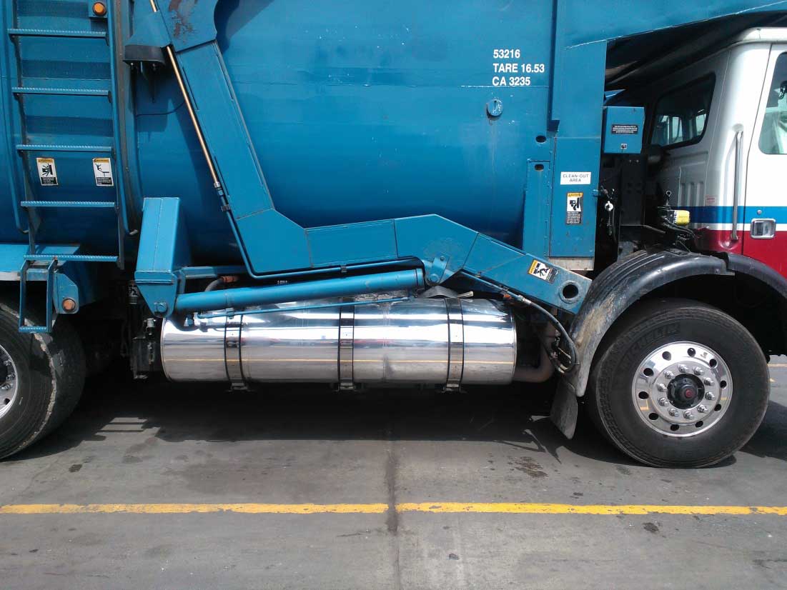 Close-up of hydraulic tank on the side of a waste collection vehicle.