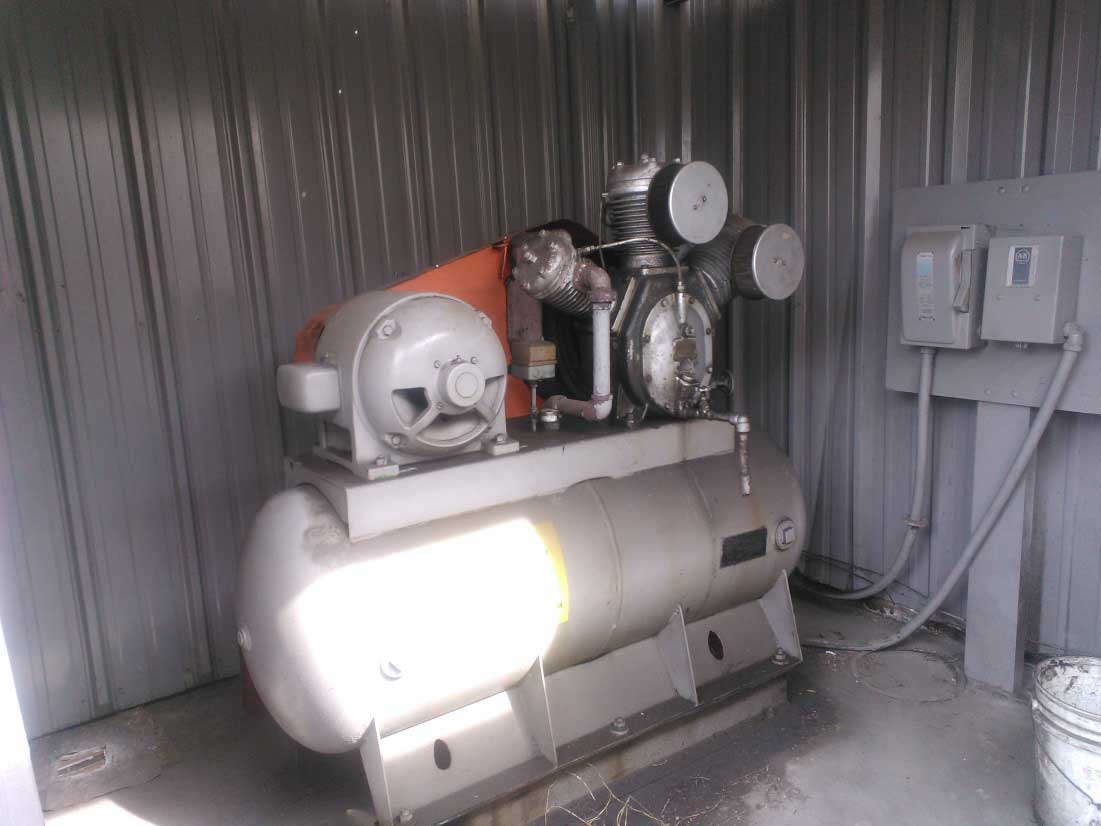The air compressor that supplied air to the entire shop is shown in the corner of the building.
