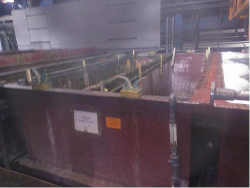 The large metal chrome plating tanks.