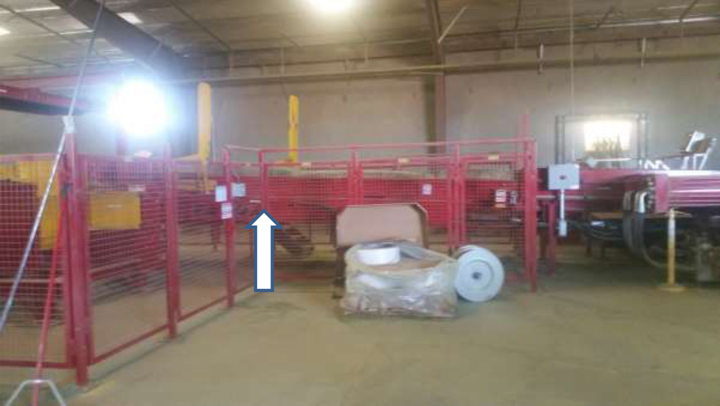 The hay baler's slicer box with an arrow indicating the position in the baling assembly.