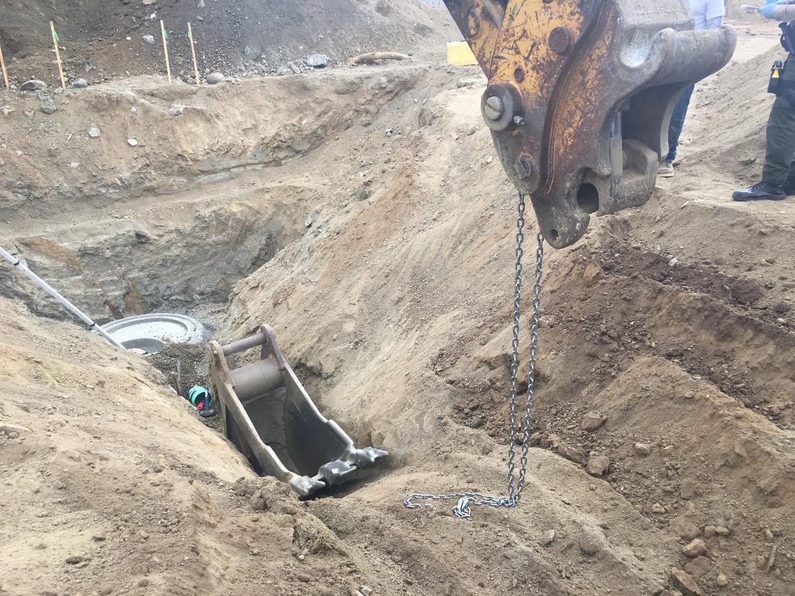 view of a trench from the side wth the detached digging bucket inside