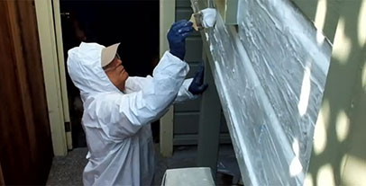 Man painting exterior wall Man painting exterior wall