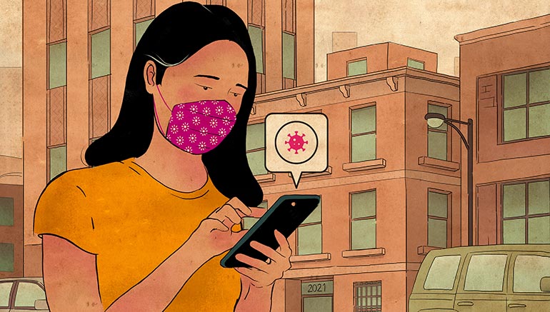 woman in face covering looking at COVID information on her cell phone