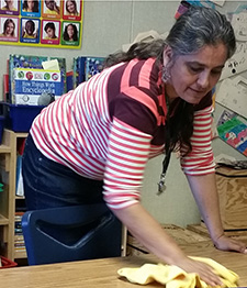 woman wiping table