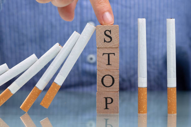 Cigarette leaning against blocks that say stop