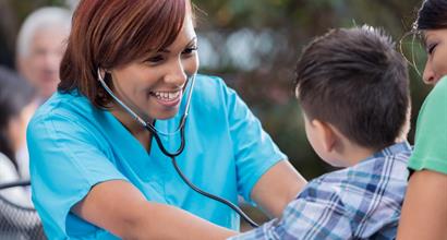 Health professional attending to child