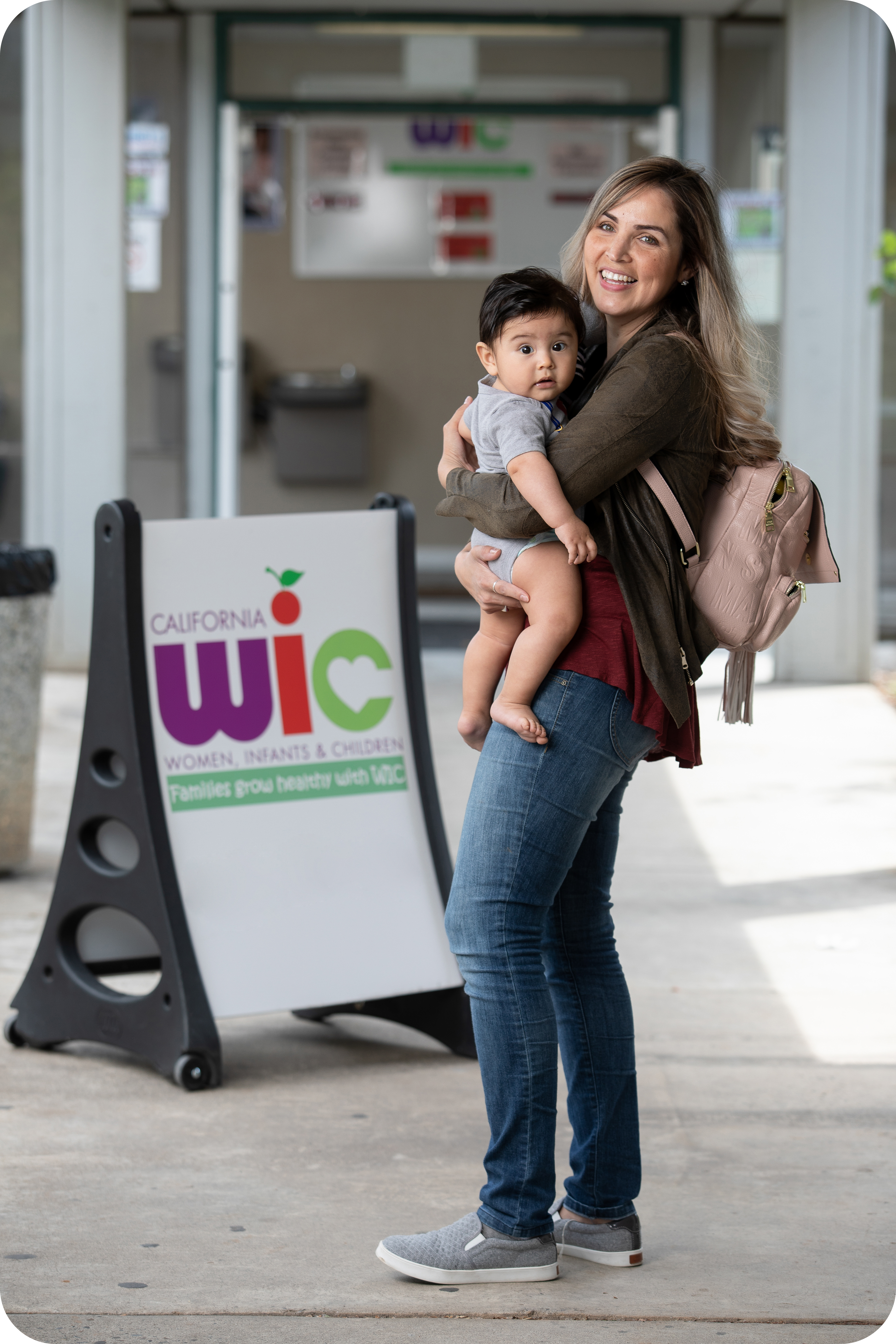 Parent holding baby outside WIC office