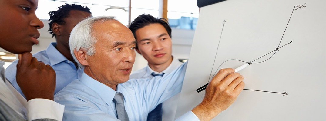 Business profesional drawing a chart on a whiteboard