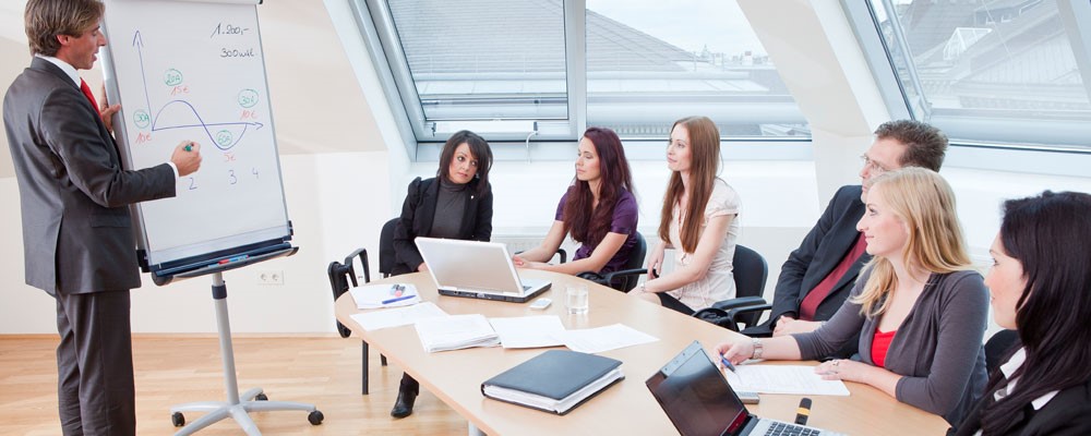 Business professsionals sitting around a conference table