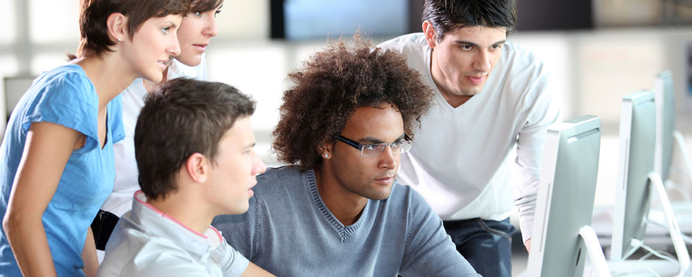 Students gathered around a computer